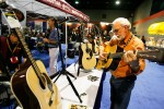 Doyle Lawson tests a new Martin at IBMA 2011 - photo © Dean Hoffmeyer Doyle Lawson tests a new Martin at IBMA 2011 - photo © Dean Hoffmeyer