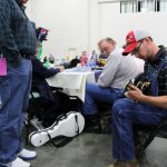 Unidentified festival goer and Johnny Ridge watching C.J. Lewandowski picking the mandolin at the South Carolina State Bluegrass Festival (11/23/12) - photo by Laura Tate Photography