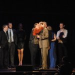 Junior Sisk hugs Tim Massey around the neck at the 2012 IBMA Awards Show - photo by Dan Loftin