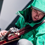 Chris Pandolfi with The Infamous Stringdusters fights the rain at the 2015 Blue Ox Music Festival - photo by Dorothy StClaire