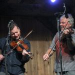 Jason Carter and Rickie Simpkins twin fiddling with The Travelin' McCourys at the August 2016 Gettysburg Bluegrass Festival - photo by Frank Baker