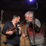 Jason Carter and guest Rickie Simpkins scheme some twin fiddle with The Travelin' McCourys at the August 2016 Gettysburg Bluegrass Festival - photo by Frank Baker