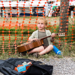 Young busker taking a break at Grey Fox 2016 - photo © Tara Linhardt