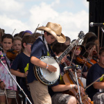 Ira Gitlin helped this student come up with a way to do his banjo parts and solo with only one hand since he broke his arm right before the festival at Kids Academy at the 2016 Grey Fox festival - photo © Tara Linhardt
