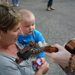 Young fan fascinated by Kelsi Harrigill and her mandolin at the 2016 Musicians Against Childhood Cancer festival - photo by Daniel Mullins
