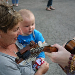 Young fan fascinated by Kelsi Harrigill and her mandolin at the 2016 Musicians Against Childhood Cancer festival - photo by Daniel Mullins