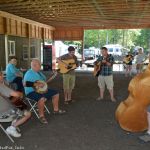 Early arrivals jamming under the shelter at the 2016 Milan Bluegrass Festival - photo © Bill Warren