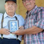 Bobby Hutch accepts his SMBMA Hall of Honor induction from Bill Warren at the 2016 Milan Bluegrass Festival - photo © Bill Warren