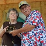 Faye Wilder accepts the SMBMA Hall of Honor induction for her and husband, Jim, from Bill Warren at the 2016 Milan Bluegrass Festival