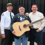 DNCHS member Bob Perry; Cherrybend guitar winner Mike Newkirk; and festival producer Joe Mullins. Photo courtesy of East Public Relations.