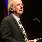 Herb Pedersen speaks during the Clarence White induction at the 2016 International Bluegrass Music Awards - photo by Frank Baker