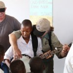 South African schoolchild tries out the banjo during a visit from the 2012 Banjo Safari crew - photo by Kevin Dooley