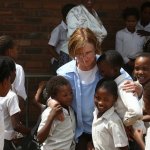 Tricia Dooley greets South African schoolchildren during a visit from the 2012 Banjo Safari crew - photo by Kevin Dooley