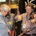 Checking out fiddles at World of Bluegrass 2015 - photo by Becky Johnson
