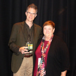 Chris Jones and his Bluegrass Broadcaster of the Year trophy with Katy Daley at World of Bluegrass 2015 - photo by Becky Johnson