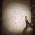 Brian Bain painting Foggy Mountain Breakdown, his portrait mural of Flatt & Scruggs at The Bluegrass Island Store in Manteo, NC