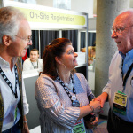 Terry and Cindy Baucom greet George Shuffler at IBMA 2011 - photo © Dean Hoffmeyer