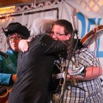 Marty Stuart gives Ryan Paisley a bear hug after they jammed at the 2015 Delaware Valley Bluegrass Festival - photo by Frank Baker