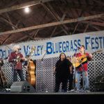 Tina Adair and Dale Ann Bradley sitting in with Ricky Skaggs & Kentucky Thunder at the 2016 Delaware Valley Bluegrass Festival - photo by Frank Baker