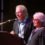 Happy and Jane Traum speak at World of Bluegrass 2016 - photo by Frank Baker