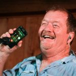 Lou Reid with Seldom Scene calls Ben Eldridge from the stage at the August Gettysburg Bluegrass Festival - photo by Frank Baker