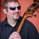 Cameron Keller with Junior Sisk & Rambler's Choice at the August 2015 Gettysburg Bluegrass Festival - photo by Frank Baker