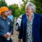 Nepali sarangi player Shyam Nepali and Peter Rowan talking music at the 2015 Grey Fox Bluegrass Festival - photo by Tara Linhardt