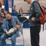 Examining a Deering banjo at WOB 2012 - photo by Woody Edwards