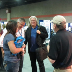 Kenny and Amanda Smith and Ricky Skaggs chatting with Terry Herd at the Bluegrass Today booth at WOB 2012 - photo by Woody Edwards