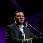 Joe Mullins addresses the Momentum Awards luncheon on Wednesday at the 2016 World of Bluegrass convention - photo © Tara Linhardt