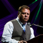 Chris Canfield from Virginia Tourism addresses the Momentum Awards luncheon on Wednesday at the 2016 World of Bluegrass convention - photo © Tara Linhardt
