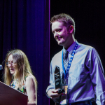Jake Workman accepts his Instrumentalist Momentum Awards at the 2016 World of Bluegrass convention - photo © Tara Linhardt