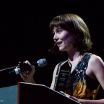 Molly Tuttle accepts her Instrumentalist Momentum Awards at the 2016 World of Bluegrass convention - photo © Tara Linhardt