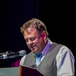 Chris Canfield from Virginia Tourism addresses the Momentum Awards luncheon on Wednesday at the 2016 World of Bluegrass convention - photo © Tara Linhardt