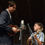 Chris Henry jamming with a young picker onstage at the 2015 Newell Lodge Bluegrass Festival - photo © Bill Warren