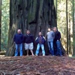 Audie Blaylock and Redline pose with a giant redwood