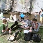 These Academy students found inspiration to sharpen their skills on the banks of the St. Vrain Saturday afternoon at RockyGrass 2013 - photo by Shannon Turner