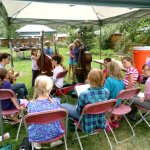 At Kids Camp, students often collaborated to share their talents. Here, the bass players work with the vocalists to learn songs like “I’ll Fly Away” - photo by Shannon Turner