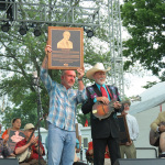 Doyle Lawson with his Hall of Fame plaque at ROMP 2014 - photo by Terry Herd