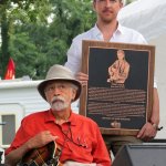 Roland White with Tony Rice\'s plaque at ROMP 2014 - photo by Terry Herd