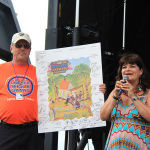 MC Cindy Baucom with the signed show poster at the 2015 Red, White & Bluegrass Festival - photo © Laura Tate Photography