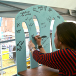 Sierra Hull signs the bench backstage at the 2015 Smithville Jamboree - photo by Bill Conger