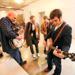 Sammy Shelor and Noam Pikelny trade banjos while Chris Thile, Paul Kowert and Gabe Witcher look on at the Sizemore Benefit Show in Roanoke (2/19/12) - photo © Dean Hoffmeyer