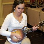 Sierra Hull checking out mandolins in the Gibson room at SPBGMA 2013 - photo by Valerie Gabehart