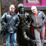 Dan Eubanks and Dustin Benson from Special C pose with the John Lennon statue at the club where The Beatles got their start in Liverpool