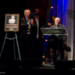 Roland White accepts brother Clarence's Hall of Fame induction during the 2016 International Bluegrass Music Awards - photo © Tara Linhardt