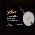 Welcome bluegrass sign at the Raleigh Airport - photo © Tara Linhardt