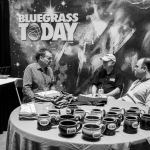 Steve Gulley and David Crow entertain Terry Herd at the Bluegrass Today booth at World of Bluegrass 2015 - photo © Tara Linhardt