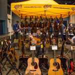 Surrounded by expensive toys at the Elderly booth at World of Bluegrass 2015 - photo © Tara Linhardt