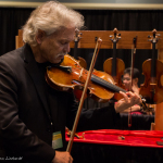 Joe Weed like countless others tries so many yummy instruments in the Exhibit Hall at World of Bluegrass 2015 - photo © Tara Linhardt
